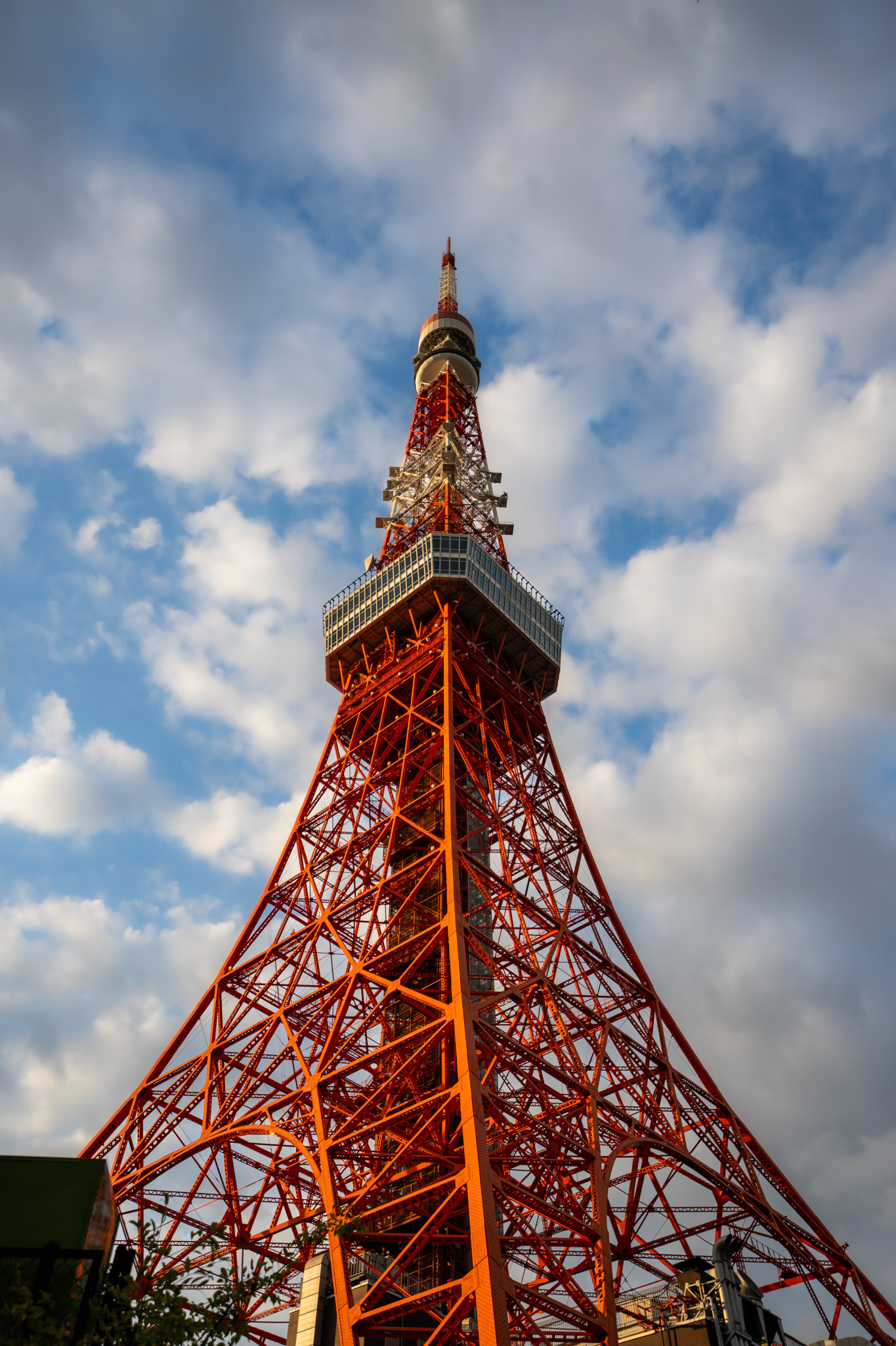 Tokyo Tower rising into a partly cloudy sky